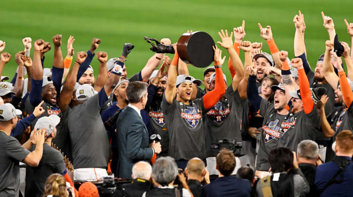 Astros shortstop Jeremy Peña holds up the World Series MVP trophy.